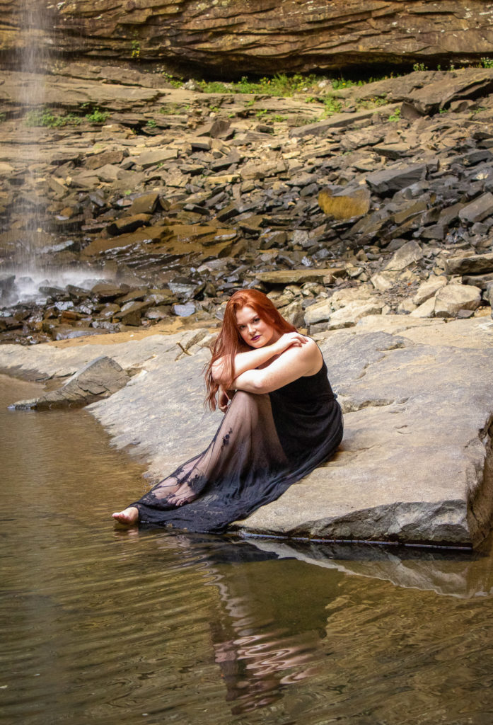 Waterfall senior portrait dark and moody vibe with nature