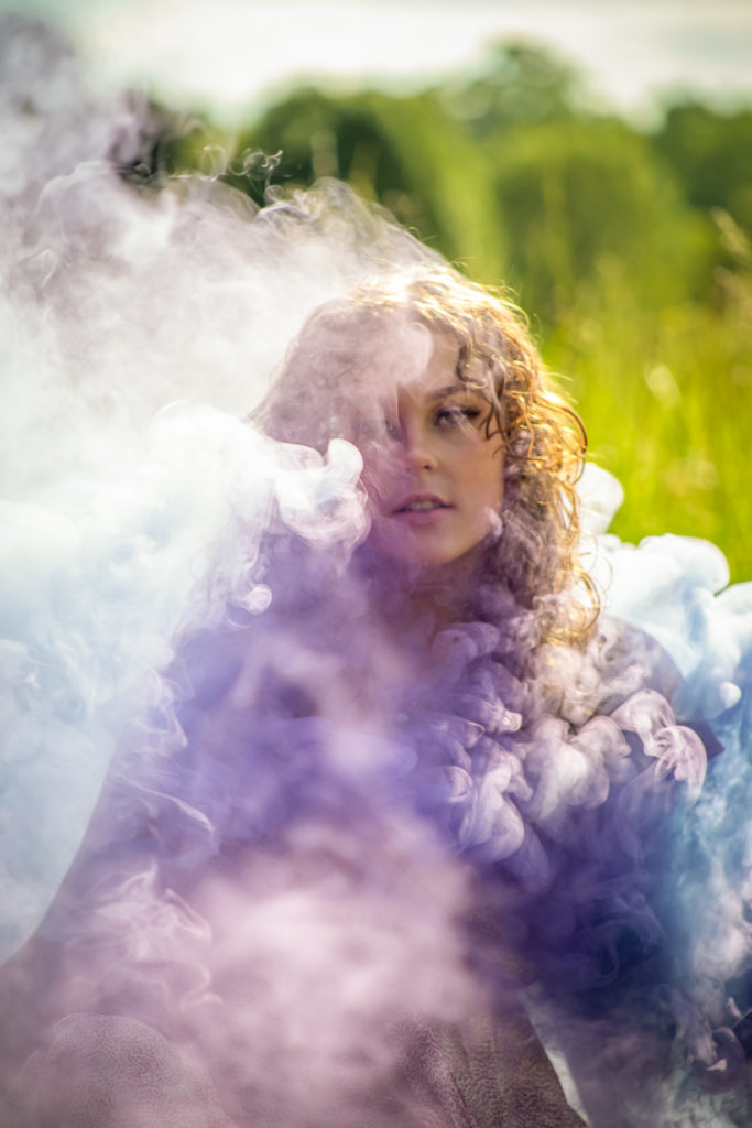 smoke bomb senior portraits on a sunny day