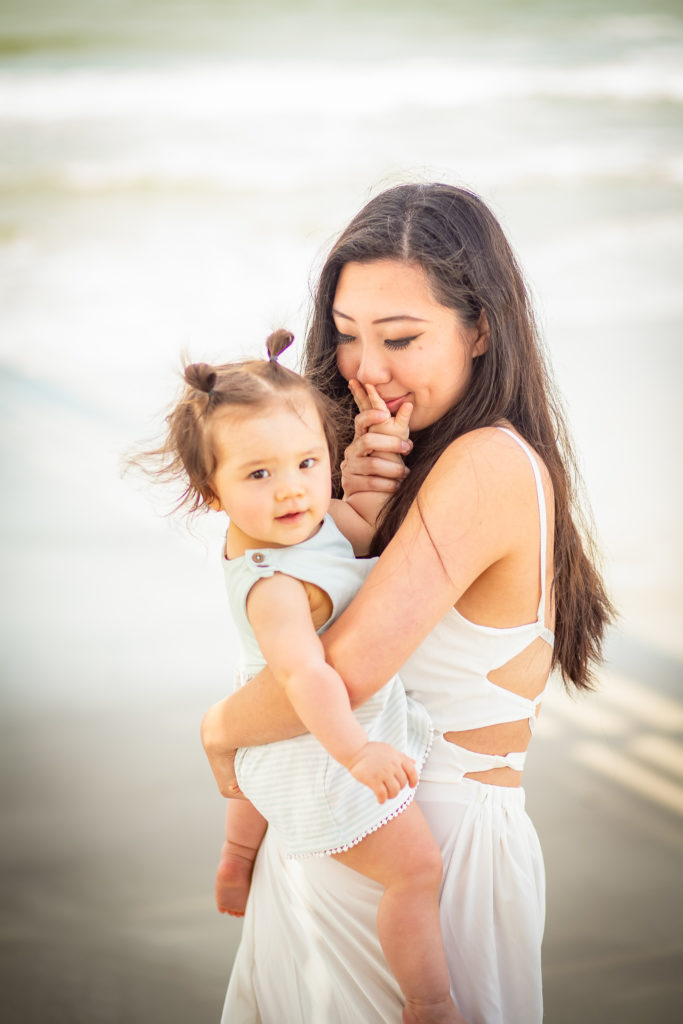 mother lovingly snuggling up to her baby mommy and me beach photography oak island beach photography